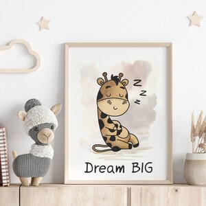 May include: A framed print with a watercolor background featuring a cartoon giraffe sleeping with the text "Dream Big" underneath. The giraffe is brown and has a light brown spot pattern. The background is a light brown with a darker brown watercolor wash.