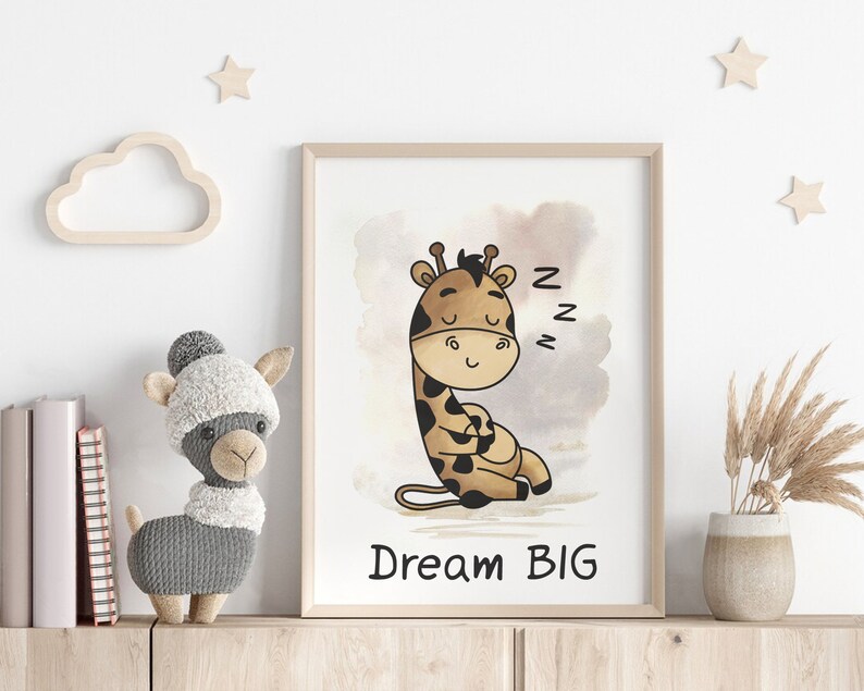 May include: A framed print with a watercolor background featuring a cartoon giraffe sleeping with the text "Dream Big" underneath. The giraffe is brown and has a light brown spot pattern. The background is a light brown with a darker brown watercolor wash.