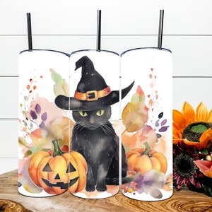 May include: Three white Halloween-themed tumblers with black straws. Each tumbler features a watercolor design of a black cat wearing a witch hat, pumpkins, and autumn foliage. The design is in shades of orange, purple, and green.