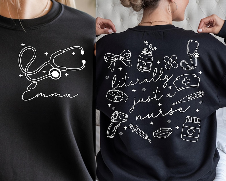 May include: Black sweatshirt with white graphic designs. The front features a stethoscope and the name "Emma". The back displays medical-themed illustrations and the phrase "literally just a nurse".