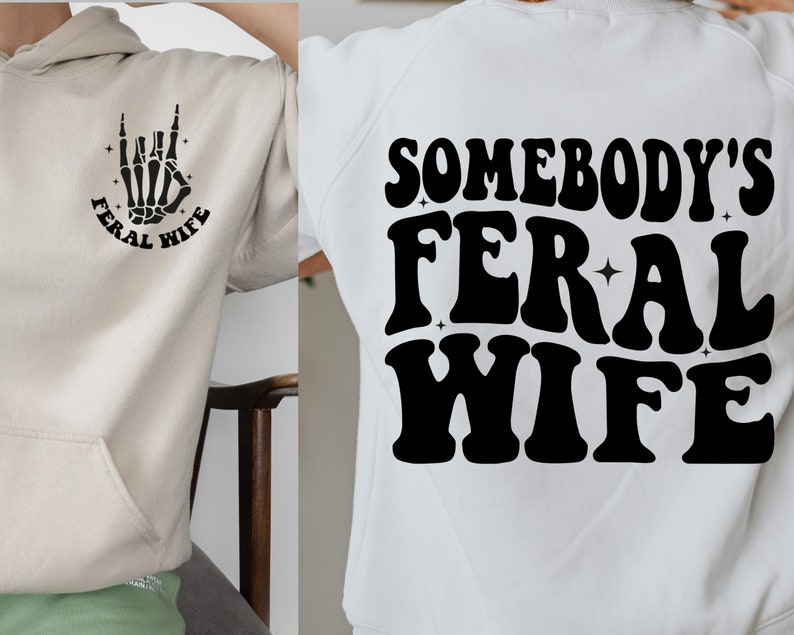May include: A white hoodie with a black graphic of a skeleton hand making a rock and roll sign with the text "Feral Wife" around it. The back of the hoodie has the text "Somebody's Feral Wife" in black.