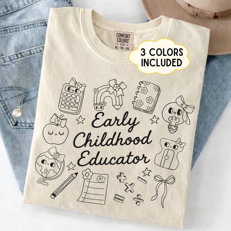 May include: Cream-colored t-shirt with a black graphic design featuring school-themed illustrations and the text "Early Childhood Educator." The design includes a calculator, rainbow, apple, and other elements.