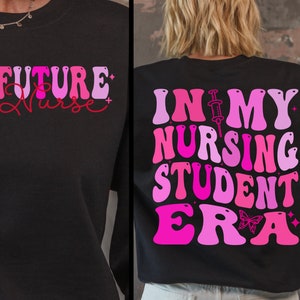 May include: Two black t-shirts with pink and red text. The front shirt says "FUTURE Nurse" and the back shirt says "IN MY NURSING STUDENT ERA" with a butterfly and a syringe.