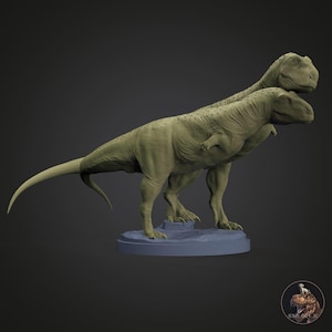 May include: Two detailed, green-toned Tyrannosaurus Rex dinosaur sculptures. The dinosaurs are posed together, one slightly behind the other, on a small, blue base. The sculptures have textured skin and are set against a dark background.