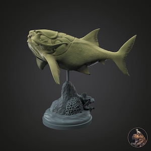 May include: A detailed, olive-green sculpture of a Dunkleosteus fish, a prehistoric armored fish, mounted on a gray base. The sculpture features intricate details of the fish's body and fins, with a textured base resembling a rocky seabed.