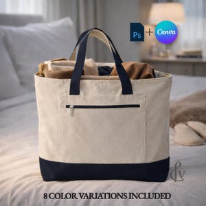 Könnte beinhalten: Eine große Canvas-Tragetasche mit cremefarbenem Korpus und marineblauen Akzenten. Die Tasche hat eine Reißverschluss-Vordertasche und marineblaue Griffe. Die Tasche ist mit verschiedenen Gegenständen gefüllt. Der Text auf dem Bild lautet "8 COLOR VARIATIONS INCLUDED."