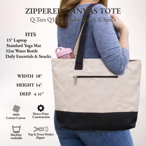 May include: A canvas tote bag with a zippered top and front pocket. The bag is beige with a black bottom and black handles. The bag is 18 inches wide, 14 inches high, and 4.5 inches deep. The bag fits a 15-inch laptop, yoga mat, and 32oz water bottle.
