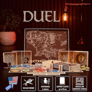 May include: A board game set with the word "DUEL" in large letters. The game includes a map, wooden game pieces, cards, and other components. The game is designed for vertical and horizontal storage.