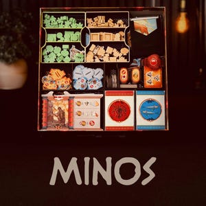 May include: A board game organizer with various compartments filled with game pieces. The organizer includes wooden tokens, cards, and other components. The word "MINOS" is displayed in white at the bottom of the image.