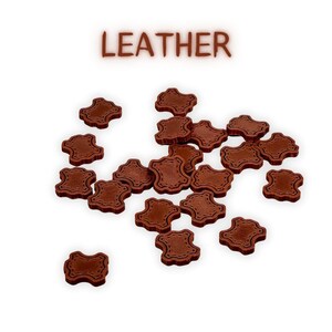 May include: A collection of brown leather patches with stitched edges, scattered on a white background. The word "LEATHER" is displayed in brown letters above the patches. These patches are likely for crafting or repair.