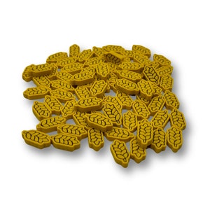 May include: A pile of yellow, wheat-shaped game pieces with black outlines. The pieces are scattered on a white background. The design is simple and clean, suitable for board games or educational purposes. Each piece is approximately 2 cm in length.