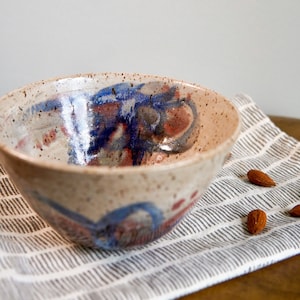 White ceramic bowl with red, blue, and gray flowers