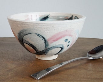 ceramic pink, black, and blue flower bowl