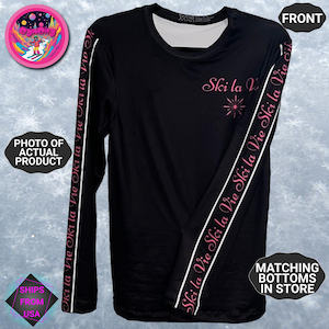 May include: Black long-sleeve shirt with the text "Ski la Vie" in pink on the chest and sleeves. White stripes run down the sleeves with the same text. The shirt has a crew neck and is labeled "Front".