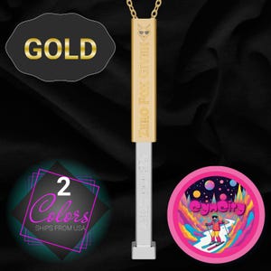 May include: Gold-colored pendant necklace with a rectangular charm. The charm has the text "ZERO FOX GIVEN" and a fox head logo. The necklace also features a white and silver rectangular charm. Additional graphics include a black oval with the word "GOLD" and a pink circle with a skier.