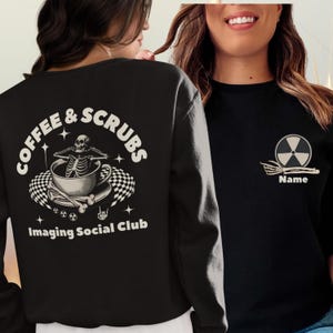 May include: Black sweatshirt with the text "COFFEE & SCRUBS" and "Imaging Social Club" with a skeleton in a coffee cup graphic on the back. The front has a radiation symbol and the word "Name".