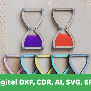 Puede incluir: Reloj de arena de madera con arena morada y naranja, con cinco relojes de arena de madera sin terminar adicionales.