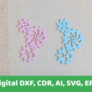 May include: Two sets of interlocking gears, one set is pink and the other is blue. The gears are made of wood and have a decorative design.