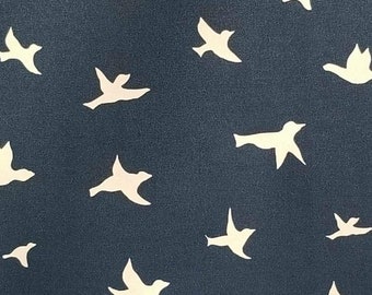 May include: Dark blue fabric with a repeating pattern of white bird silhouettes in various poses. The birds are evenly spaced across the background, creating a sense of movement and flight.