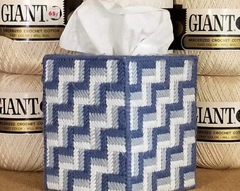 May include: A blue and white woven tissue box cover with a geometric pattern. The cover is sitting on a shelf with spools of yarn labeled "Giant" mercerized crochet cotton.
