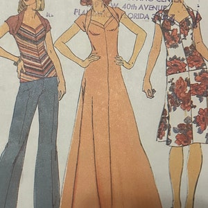 May include: A vintage sewing pattern featuring three women's clothing designs. The first design is a striped top with a matching cardigan and blue jeans. The second design is a long, peach-colored dress with a V-neck and a button-up front. The third design is a floral print dress with short sleeves. The pattern is titled "#22 Classic World of Patterns" and includes the text "Shopping Center, 40th Avenue, Florida 33163".
