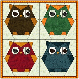 May include: Four colourful owl-shaped fabric patchwork blocks. The owls are brown, green, red, and blue. Each owl has large, white eyes with black pupils.