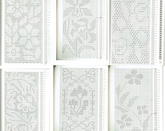 May include: Six black and white cross-stitch patterns for embroidery. Each pattern is on a grid with numbers and letters along the sides. The patterns feature floral designs.