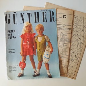 May include: A vintage sewing pattern magazine cover featuring two children, a girl in a red dress and a boy in a green vest and shorts. The magazine is titled "GÜNTHER" and the text "PETER und PETRA" is also visible. The magazine cover is blue and features a light blue background.