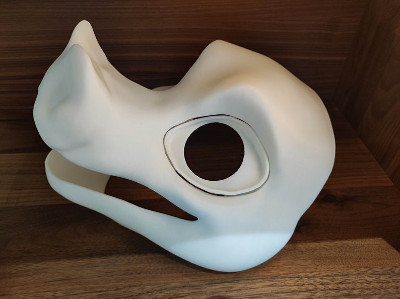 May include: White unfinished resin blank fursuit head base with a single eye hole and a large snout.