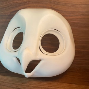 May include: White unpainted owl fursuit head base with eye and mouth openings.