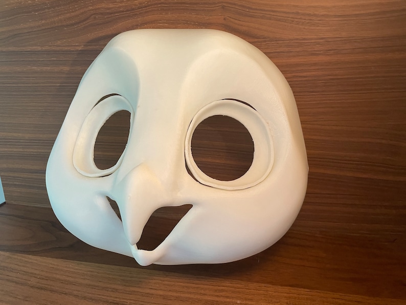 May include: White unpainted owl fursuit head base with eye and mouth openings.