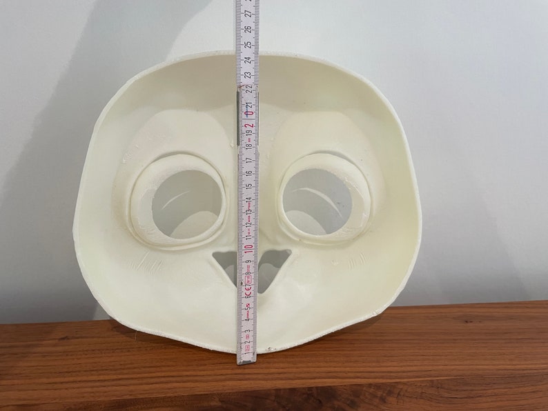 May include: White plastic mask with two large eye holes and a small mouth hole. The mask is approximately 18 inches tall.