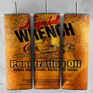May include: A rusty yellow and orange metal tumbler with a black and white image of a man using a wrench. The text "Liquid Wrench Penetrating Oil" is printed on the tumbler. The text "Frees stuck nuts, bolts and locks" is printed below the image. The text "Dissolves rust, cuts through grease" is printed below the text "Frees stuck nuts, bolts and locks".