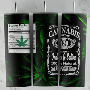 May include: A black and green stainless steel tumbler with a cannabis leaf design and the text "Cannabis Old 420 Brand Quality Indica & Sativa 100% Natural. Grown Locally All Over The Globe Good People Disobey Bad Laws".