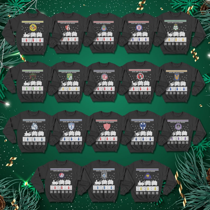 May include: A selection of dark grey sweatshirts featuring soccer team logos and a train design. Each sweatshirt displays the text "ESTE A&Ntilde;O ES EL BUENO" above the train. The sweatshirts are presented against a green backdrop with festive decorations.