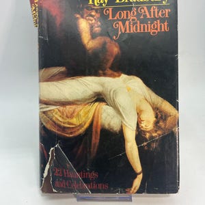 May include: Vintage paperback book titled "Long After Midnight" by Ray Bradbury. The cover features a dark, dramatic illustration of a figure lying down, with a shadowy figure above. The book's title is in a decorative font, with the subtitle "22 Hauntings and Celebrations".