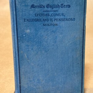 May include: A vintage book with a blue cover and dark blue border. The title "Merrill's English Texts" is printed at the top, with "Lycidas, Comus, L'Allegro, and Il Penseroso" below. The author's name, "Milton," is at the bottom.