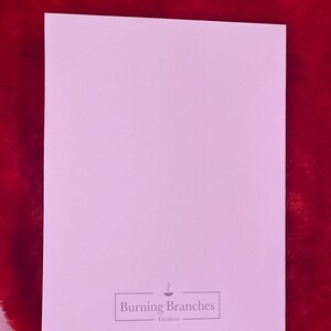 May include: A blank, light pink card with the text "Burning Branches Creatives" in a black rectangle at the bottom.