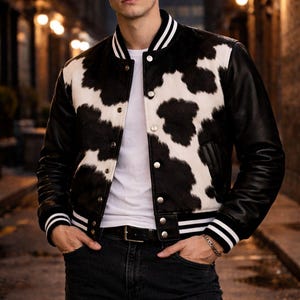 Black & White Cowhide Varsity Jacket – Hair-On Leather Bomber Black Sleeves – Unisex Rodeo Streetwear Black Varsity