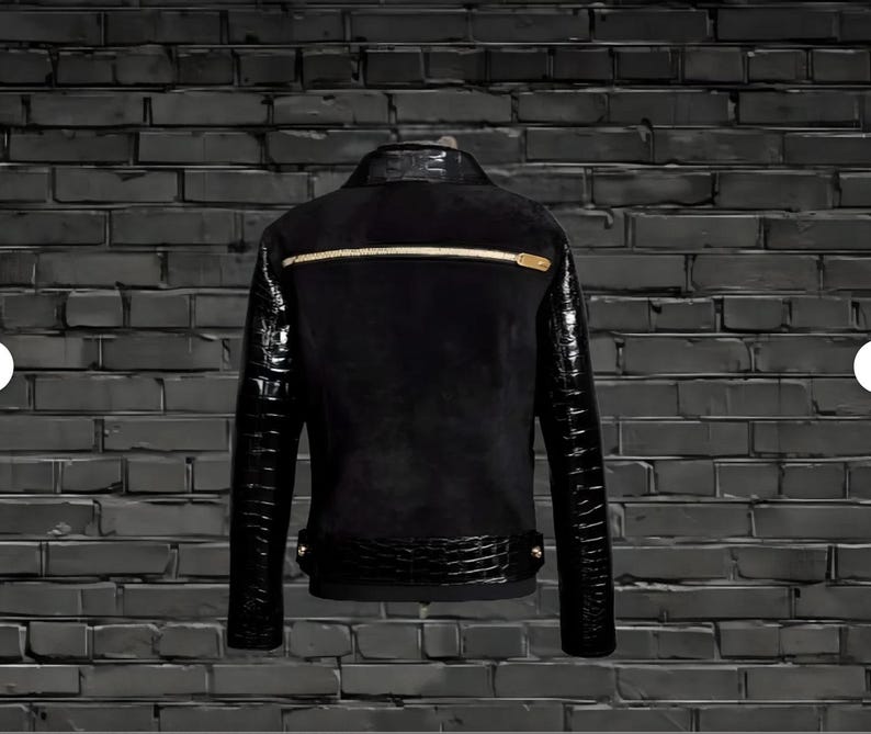 May include: Black leather jacket with crocodile-embossed sleeves and a gold zipper. The jacket has a suede-like texture and a black background.