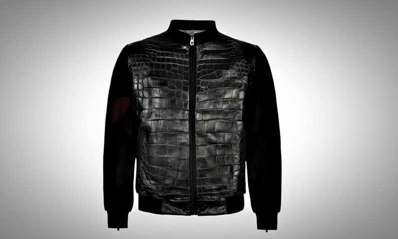 May include: A black bomber jacket with a crocodile skin pattern on the front and black sleeves.