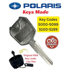 May include: A silver metal key for Polaris vehicles with a textured head and a triangular cutout. Text includes Polaris, Keys Made, and Key Codes 5000-5099, 5100-5199. A smaller image shows an original OEM key with a black plastic cap and a metal tag.