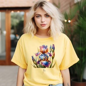 May include: A yellow t-shirt with a colorful iris flower graphic and the word "Iris" printed below the graphic.