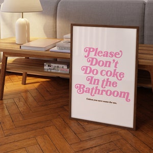 May include: A framed print with a pink and white design that says "Please Don't Do Coke In The Bathroom" with the text "Unless you save some for me." underneath.