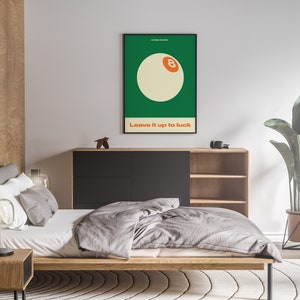 May include: A minimalist poster with a green background and a white 8-ball with an orange number 8. The text "Leave it up to luck" is printed below the 8-ball.