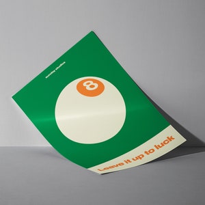 May include: A green poster with a white 8-ball and the text "Leave it up to luck". The poster is from Sunday Studios.
