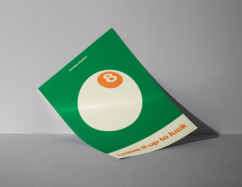May include: A green poster with a white 8-ball and the text "Leave it up to luck". The poster is from Sunday Studios.
