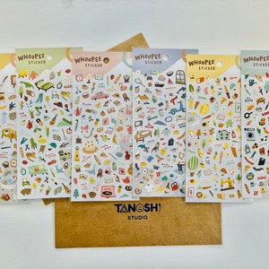 May include: Six sheets of colorful stickers with various illustrations. Each sheet has the word "WHOOPEE STICKER" at the top. The stickers feature a variety of illustrations, including animals, food, and household items. The sheets are arranged in a row on a brown surface.