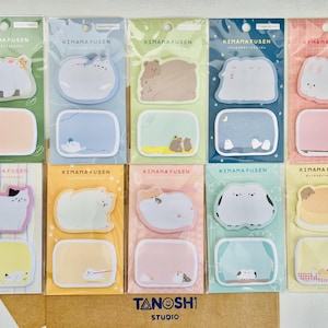 May include: A collection of Kimana Fusen sticky notes featuring adorable animal illustrations. Each pack includes a shaped note and a rectangular note, with designs like bears, cats, and bunnies. The packaging includes the text "KIMANA FUSEN" and "TANOSHI STUDIO".