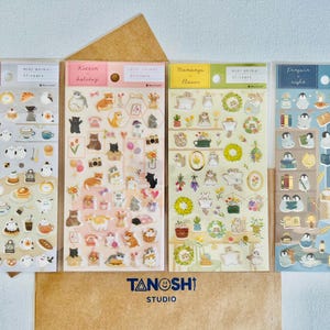 May include: Four sheets of stickers featuring various animal illustrations. The stickers are organized into four categories: "Slime Cafe", "Mini Animal Stickers", "Kitten Holiday", "Mamango Flower", and "Penguin Night". Each sheet has a different color background and features a variety of cute animal designs.